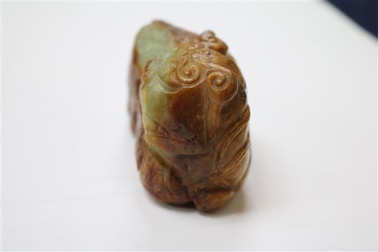 A Chinese greenish yellow and russet jade figure of a Buddhist lion, 17th/18th century 8cm.